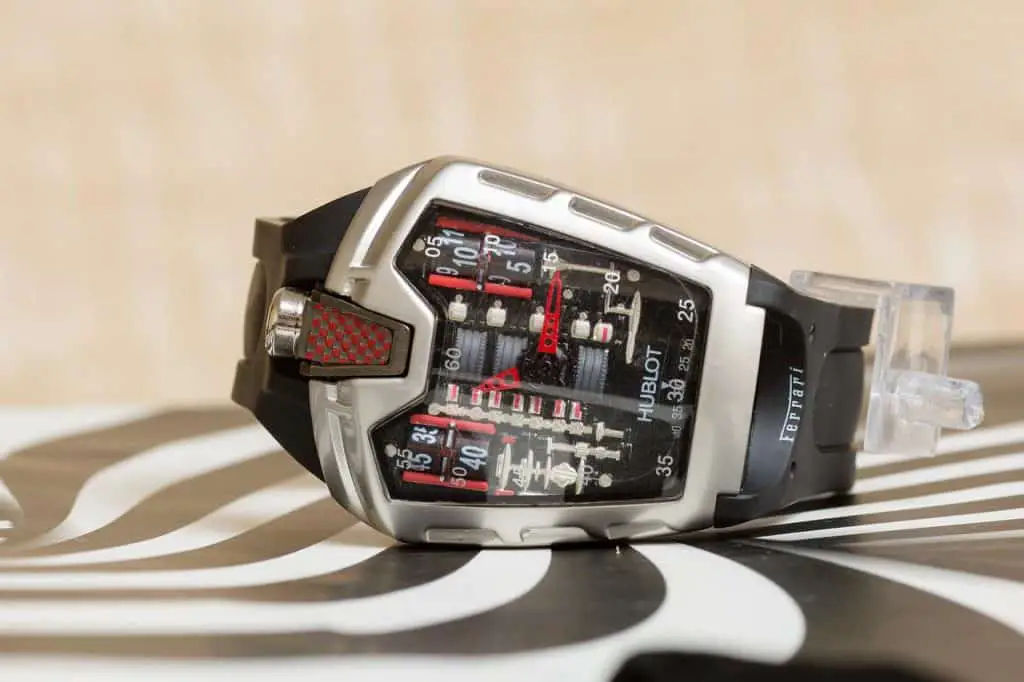 A Hublot Ferrari watch. The watch sits atop a black and white countertop.